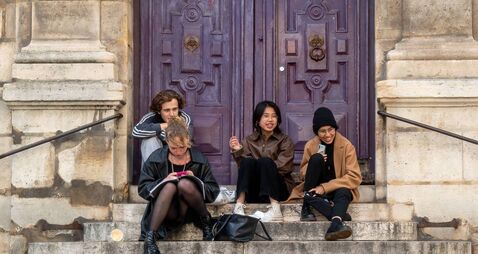 A small group of students from Paris Université (Paris, France) sit on the steps of the Église Saint-Étienne-du-Mont in front of