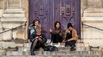 iStock-1344594587.jpg A small group of students from Paris Université (Paris, France) sit on the steps of the Église Saint-Étienne-du-Mont in front of