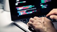 2T2FYM3 Hacker with malware code in computer screen. Cybersecurity, privacy or cyber attack. Programmer or fraud criminal writing virus
