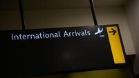 2YN7HR4 Airport signage for international arrivals