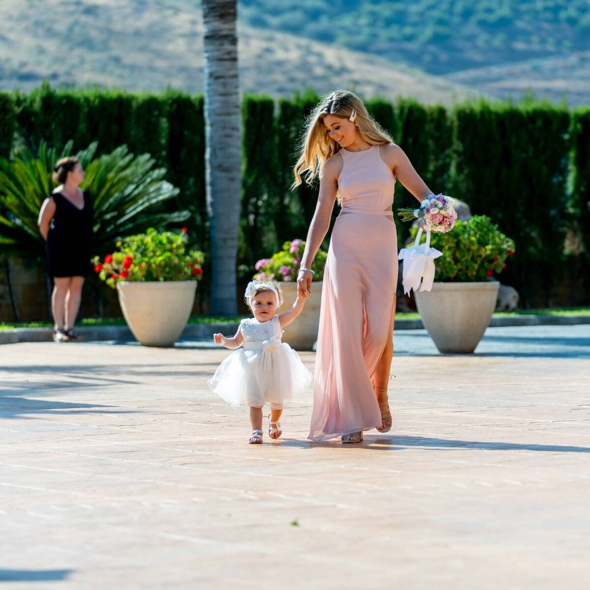 George McMahon and Rachel Smyth's daughter, Frankie, walks up the aisle with her godmother Eve. Picture: Dougie Farrelly. George McMahon and Rachel Smyth's daughter, Frankie, walks up the aisle with her godmother Eve. Picture: Dougie Farrelly.
