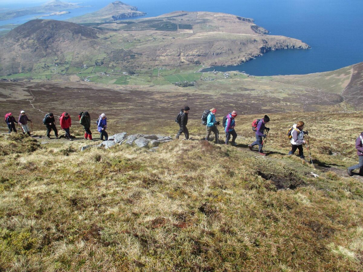 Pilgrim walkers ascending Cnoc na dTobar mountain route in south Kerry. Pilgrim walkers ascending Cnoc na dTobar mountain route in south Kerry.