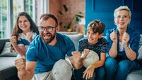 Family enjoys an exciting soccer match together at home, celebrating every goal with joy and enthusiasm