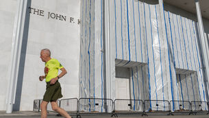 A person jogs outside of the John F. Kennedy Centre for the Performing Arts (Jose Luis Magana/AP) A person jogs outside of the John F. Kennedy Centre for the Performing Arts (Jose Luis Magana/AP)