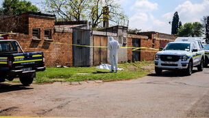 A forensic officer at the scene where a sixth body was found in KwaThema, Springs (STR/AP) A forensic officer at the scene where a sixth body was found in KwaThema, Springs (STR/AP)