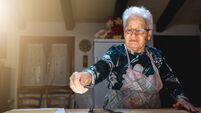 Caucasian grandmother, senior old woman cooking in her kitchen traditional recipes of Italian couture. Homemade pasta.