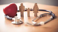 Medical Insurance Concept With Family  And Stethoscope On Wooden Desk