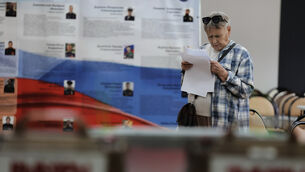 A voter holds her ballot prior to voting in the parliamentary election in Vladivostok, Russia (AP) A voter holds her ballot prior to voting in the parliamentary election in Vladivostok, Russia (AP)