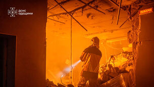 Emergency services personnel work to extinguish a fire following a Russian air attack in Odesa, Ukraine (Ukrainian Emergency Service via AP)