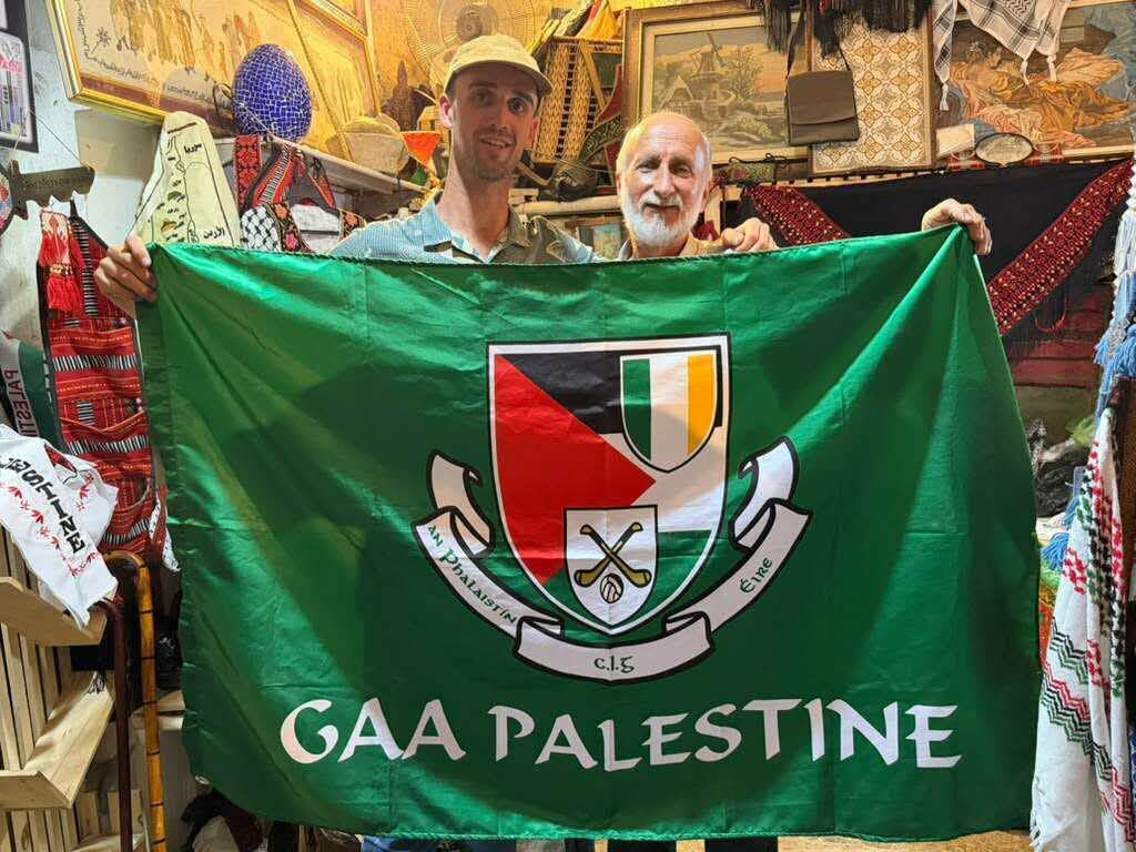 James Ryan from Fermoy in Cork, who volunteered with the anti-occupation initiative Protective Presence, with a shop owner in Palestine who presented him with a GAA Palestine flag. James Ryan from Fermoy in Cork, who volunteered with the anti-occupation initiative Protective Presence, with a shop owner in Palestine who presented him with a GAA Palestine flag.