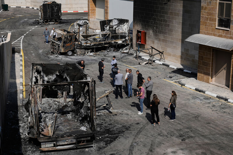 Palestinians and journalists survey damage in an industrial zone following an attack by Israeli settlers in the West Bank village of Beit Lid, near Tulkarm in November, 2025. Picture: Majdi Mohammed/AP Palestinians and journalists survey damage in an industrial zone following an attack by Israeli settlers in the West Bank village of Beit Lid, near Tulkarm in November, 2025. Picture: Majdi Mohammed/AP
