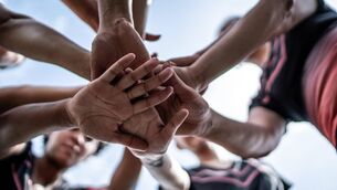 <p>Close-up of female soccer team stacking hands in the field</p> <p>Close-up of female soccer team stacking hands in the field</p>