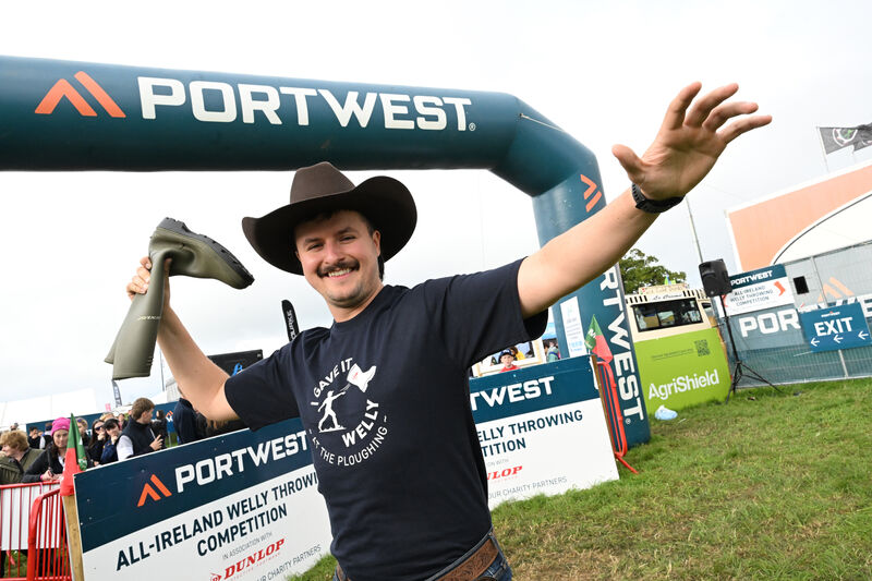  The 'Kerry Cowboy' Séaghan Ó Súilleabháin tries his hand at the welly-throwing competition at the Portwest stand in association with Dunlop, with proceeds going to the charity SOSad. Picture: Larry Cummins