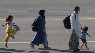 <p>A family fleeing the Taliban in 2021 arriving at Melsbroek military air base in Belgium. Women and girls left behind in Afghanistan have been excluded from 'public life, employment, education, and access to justice'. Picture: Johanna Geron/Reuters</p>