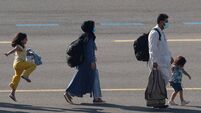 People who have been evacuated from Afghanistan arrive at Melsbroek military airport