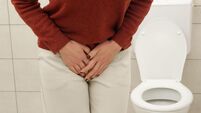 Woman Experiencing Lower Abdominal and Bladder Pain in Bathroom ? Urinary Tract Infection, Cystitis, Cramps and Digestive Discom