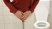 Woman Experiencing Lower Abdominal and Bladder Pain in Bathroom ? Urinary Tract Infection, Cystitis, Cramps and Digestive Discom