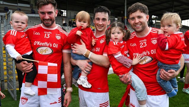 <p>Rathmore players, from left, Brendan O'Keeffe with his son Cian, Paul Murphy and his daughter Lucy, and Mark Reen and his children Ivy and Louis celebrate after the Kerry Senior Club Football Championship Final between Dr Crokes and Rathmore at Fitzgerald Stadium in Killarney, Kerry. Photo by Brendan Moran/Sportsfile</p>