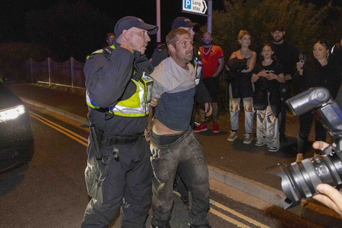 A person is led away by police during a protest in Gosport, Hampshire after police closed off the access road to Haslar Marina, after British rescue boats have been sent to collect the passengers of a migrant dinghy which has spent around 30 hours at sea. Picture date: Tuesday September 22, 2026. PA Photo. Photo credit should read: Trevor Adams/PA Wire A person is led away by police during a protest in Gosport, Hampshire after police closed off the access road to Haslar Marina, after British rescue boats have been sent to collect the passengers of a migrant dinghy which has spent around 30 hours at sea. Picture date: Tuesday September 22, 2026. PA Photo. Photo credit should read: Trevor Adams/PA Wire