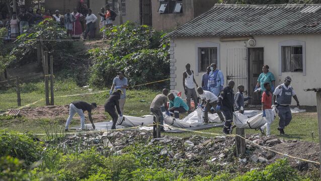 <p>South African forensic pathology personnel are assisted by community members to carry the body of a victim following a mass shooting in the Ziko area of KwaMakhutha, south of Durban on September 23, 2026. Photo by Rajesh Jantilal/ AFP via Getty Images</p>