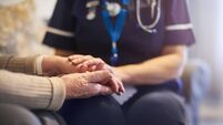 Nurse comforting patient at patient's home