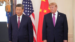 US President Donald Trump (right) and Chinese President Xi Jinping participate in the arrival ceremony (Jacquelyn Martin/AP/PA)