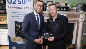 <p>Central Bank Deputy Governor Vasileios Madouros presented the coin to Larry Mullen Jr. in attendance on behalf of the band. Picture Conor McCabe </p>