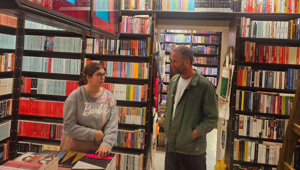 Irish Examiner writer Colin Sheridan speaks with Libenta Spahija at Buzuku bookshop in central Pristina.
