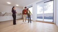 iStock-2268499596.jpg Real estate agent showing a modern apartment interior to a young couple.