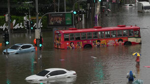 Heavy rain has flooded the streets of Bangkok (AP)