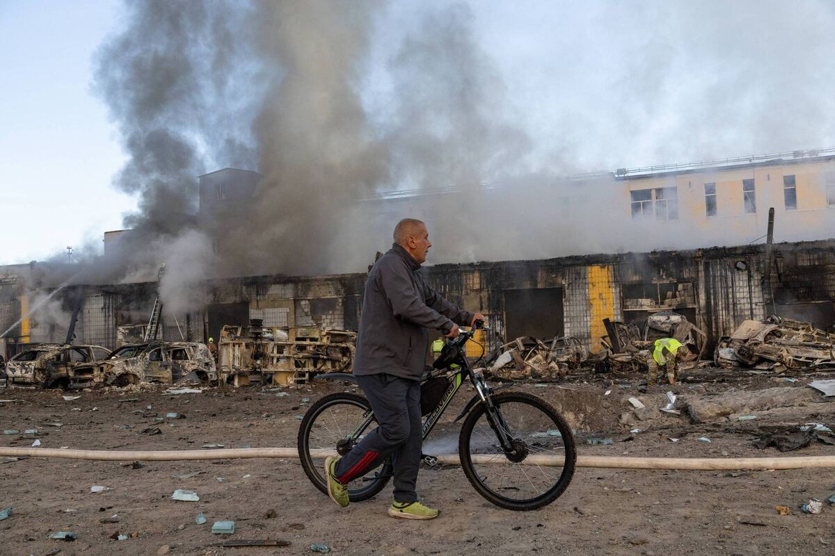 A man carries his bicycle as he past firefighters pushing out a fire following Russian missiles strikes in Kyiv early on September 8, 2026, amid the Russian invasion in Ukraine. Picture: Serhii Okunev / AFP via Getty Images A man carries his bicycle as he past firefighters pushing out a fire following Russian missiles strikes in Kyiv early on September 8, 2026, amid the Russian invasion in Ukraine. Picture: Serhii Okunev / AFP via Getty Images