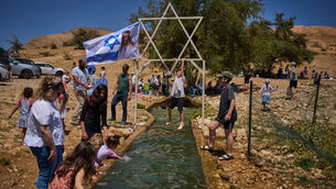 A child climbs on a metal Star of David structure at a spring in Auja, in the Jordan Valley, during Israel’s Independence Day on April 22 (AP)