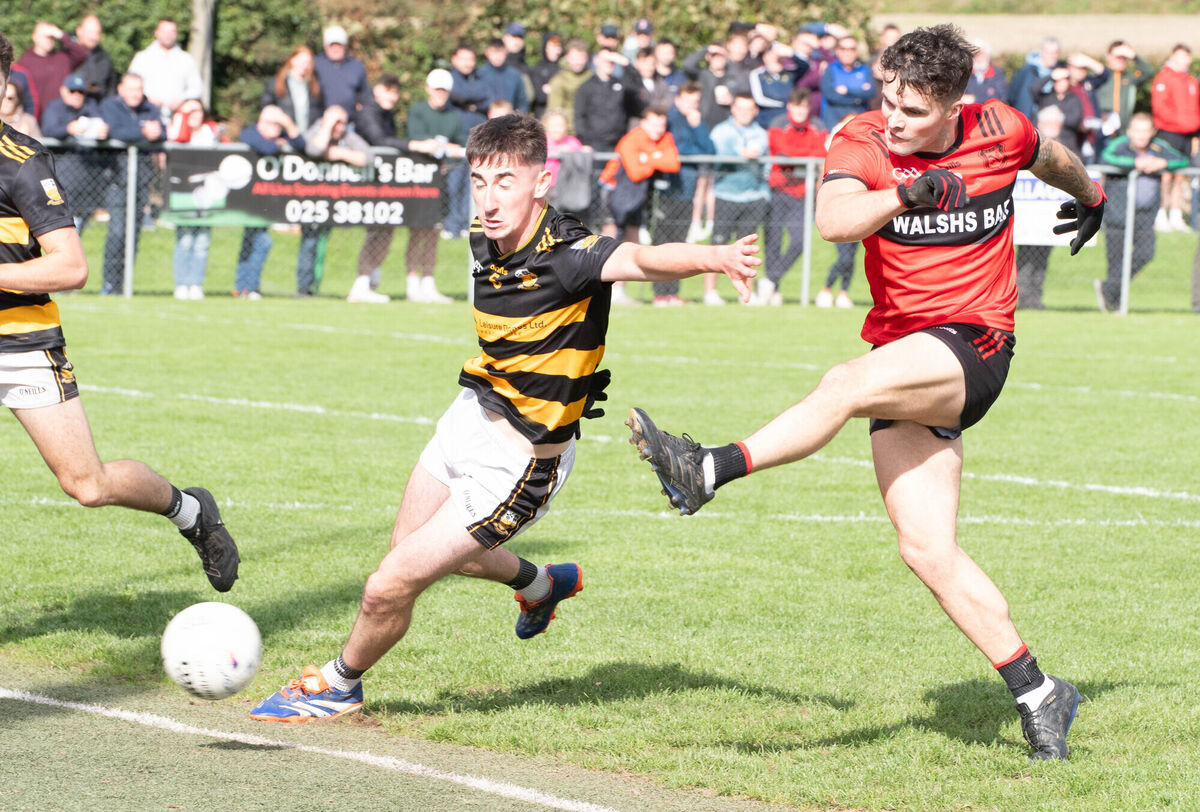 Mitchelstown's Ronan Murphy scores his side's opening despite the efforts of Buttevant's Aaron Trimm in Glanworth. Pic: Howard Crowdy