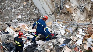 Firefighters work at the scene (Yorgos Karahalis/AP)