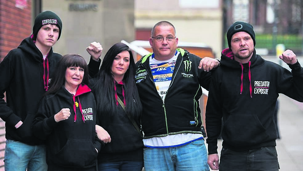 Members of paedophile-hunting group Predator Exposure, two of whom identified themselves as Christine (second left) and Phil (right) (no surnames given), outside Leeds Crown Court after the sentencing of TV producer Kieran Creaven. Picture: Peter Powell/PA