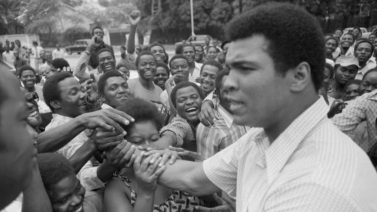 Muhammad Ali is greeted in Kinshasa, Zaire, before the 'Rumble in the Jungle'. (AP Photo)