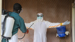A healthcare worker in protective clothing is disinfected by a colleague inside a treatment center for Ebola patients in Beni, North Kivu province, eastern Congo, Saturday, Sept. 26, 2026. (Sebastien Kitsa Musayi/AP)