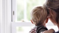 Mother and son looking out of the window
