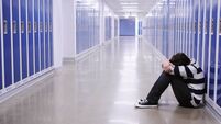 Depressed Boy in School Hallway