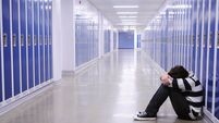 Depressed Boy in School Hallway