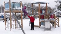A family of Caucasians at the playground. Winter weekend getaway. Young woman with a baby boy 5 years old.