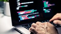 Hacker with malware code in computer screen. Cybersecurity, privacy or cyber attack. Programmer or fraud criminal writing virus