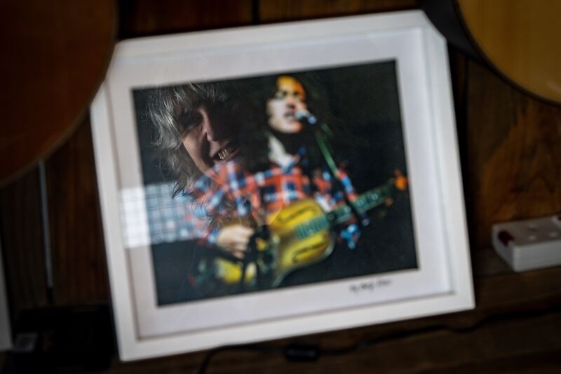 Sheena Crowley is reflected in a photograph of legendary Cork musician Rory Gallagher, one of the famous customers associated with Crowleys Music Centre. Picture: Chani Anderson Sheena Crowley is reflected in a photograph of legendary Cork musician Rory Gallagher, one of the famous customers associated with Crowleys Music Centre. Picture: Chani Anderson