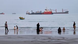 <p>People spend time at a beach as commercial vessels are anchored in the Strait of Hormuz off Bandar Abbas, Iran. Picture Amirhosein Khorgooi/ISNA via AP</p> <p>People spend time at a beach as commercial vessels are anchored in the Strait of Hormuz off Bandar Abbas, Iran. Picture Amirhosein Khorgooi/ISNA via AP</p>