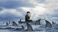 Man Reading Newspaper Surrounded By Sharks