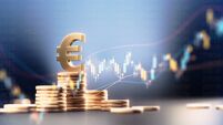 Euro Symbol On Top Of Coin Stacks Before Blue Financial Graph