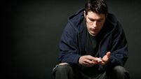 Depressed Young Caucasian Man Holding Prescription Medication