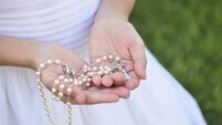 Rosary in Girl's hands