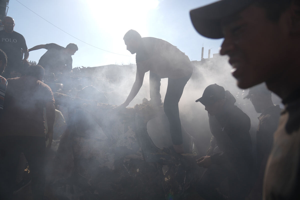 People operate on a destroyed vehicle following an Israeli airstrike in Gaza last month. Photo: AP/Jehad Alshrafi People operate on a destroyed vehicle following an Israeli airstrike in Gaza last month. Photo: AP/Jehad Alshrafi