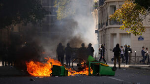 Police stand in front of burning garbage in Paris (Aurelien Morissard/AP) Police stand in front of burning garbage in Paris (Aurelien Morissard/AP)